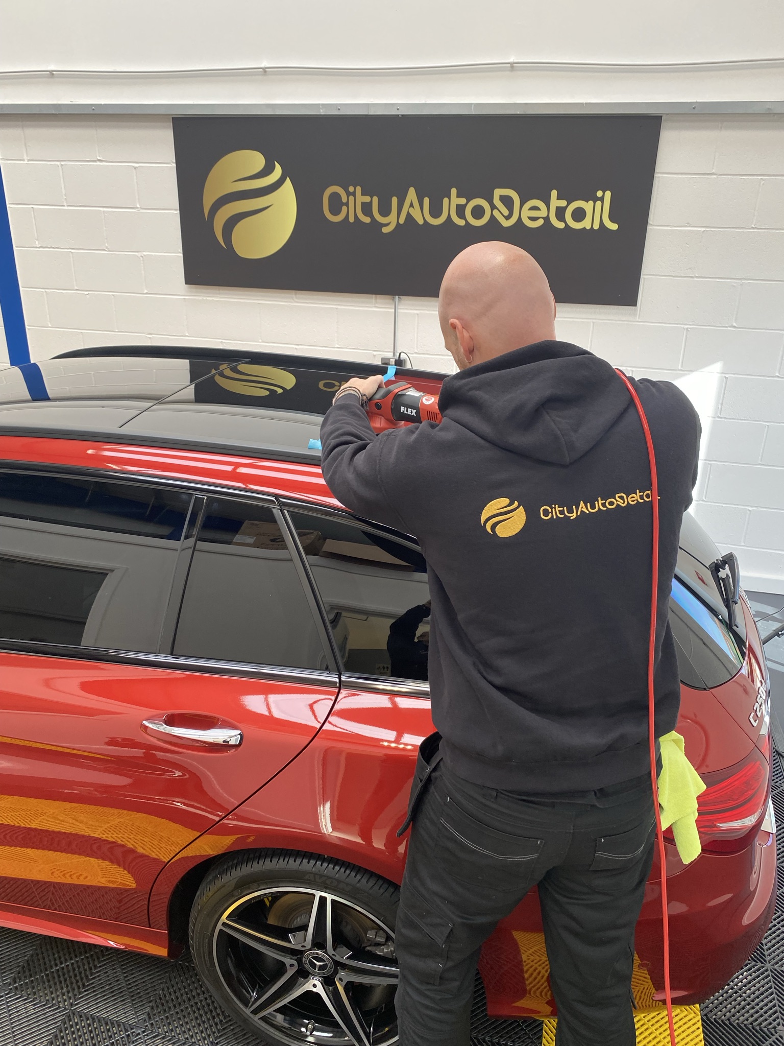 car being polished during a vehicle detail and valet service